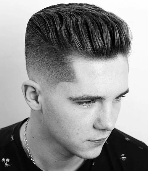 This brush back with a low skin fade delivers a classic style with a clean