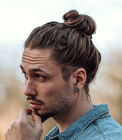 The man bun is a trendy, longer men’s hairstyle that pulls the length into the back