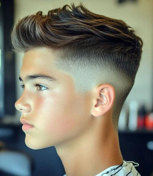 This modern quiff with a mid-low skin fade is a trendy, striking look