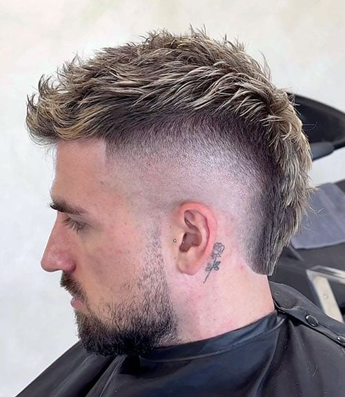 A mohawk with a high burst fade offers a hardcore, attitude-filled statement hairstyle