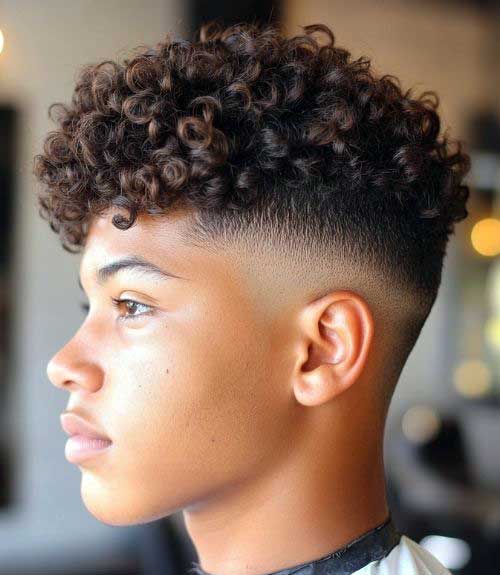 Thick curls with a perfect low-cut skin fade is a mature yet charming cut