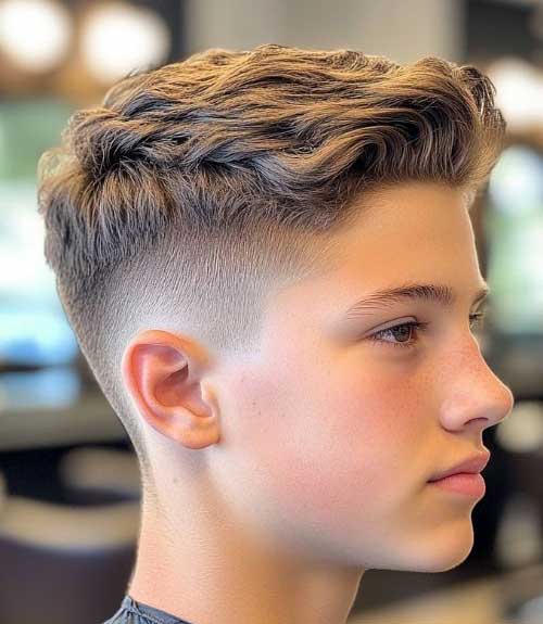 This fashionable long hairstyle on top with short, blended sides offers versatility